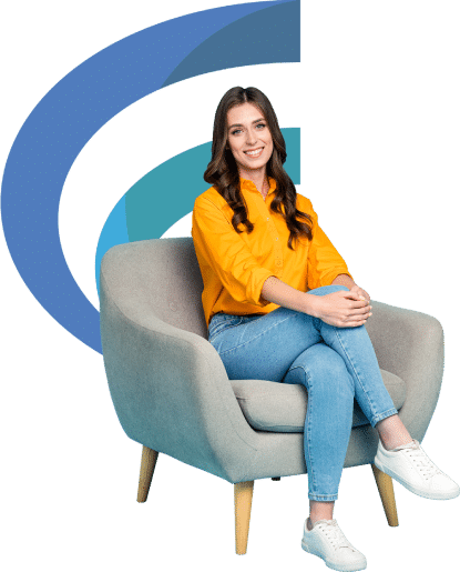 A smiling woman sitting on a grey sofa chair