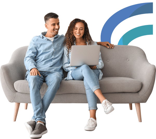 Couple sitting on a couch with a laptop making an online payment